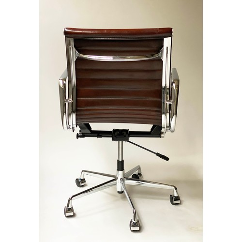 111 - REVOLVING DESK CHAIR, Charles and Ray Eames inspired ribbed, mid brown leather, revolving and reclin... 