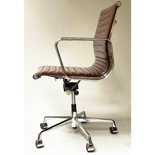 111 - REVOLVING DESK CHAIR, Charles and Ray Eames inspired ribbed, mid brown leather, revolving and reclin... 