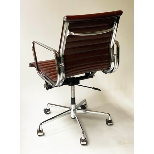 111 - REVOLVING DESK CHAIR, Charles and Ray Eames inspired ribbed, mid brown leather, revolving and reclin... 