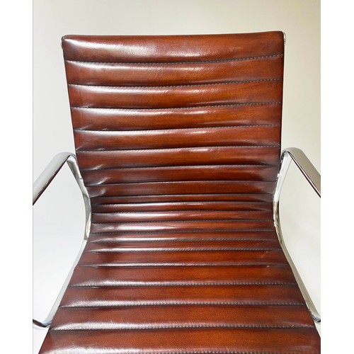 111 - REVOLVING DESK CHAIR, Charles and Ray Eames inspired ribbed, mid brown leather, revolving and reclin... 