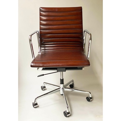 111 - REVOLVING DESK CHAIR, Charles and Ray Eames inspired ribbed, mid brown leather, revolving and reclin... 