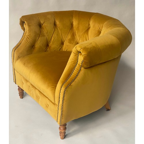 127 - TUB ARMCHAIR BY ALEXANDER & JAMES, bow backed studded and buttoned mustard yellow velvet with scroll... 