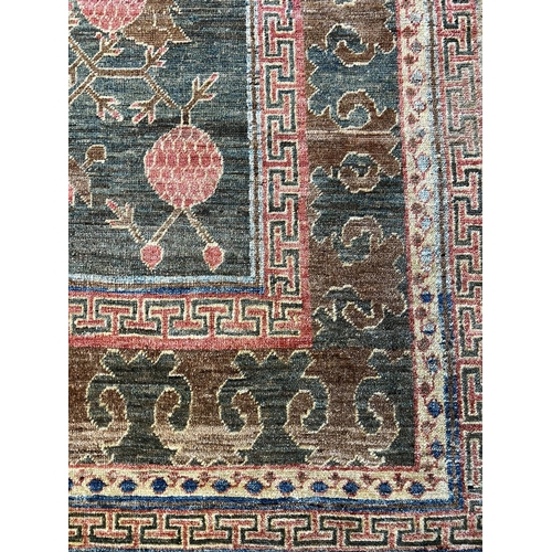 111 - FINE KHOTAN POMEGRANITE DESIGN CARPET, 313cm x 223cm.