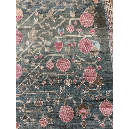 111 - FINE KHOTAN POMEGRANITE DESIGN CARPET, 313cm x 223cm.