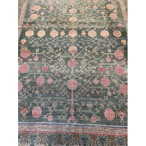 111 - FINE KHOTAN POMEGRANITE DESIGN CARPET, 313cm x 223cm.