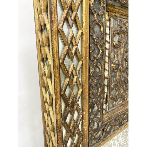 504 - NORTH INDIAN WALL MIRROR, late 19th/early 20th century giltwood, with lattice mirror marginal frame ... 