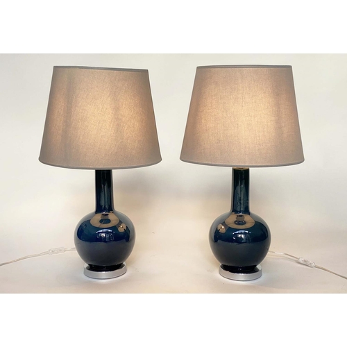 117 - OKA TABLE LAMPS, a pair, Grenadilla by Oka deep bottle green glass with shades, 74cm H. (2)