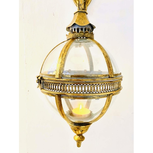 448 - GLOBULAR WALL HANGING CANDLE LANTERNS, a pair, regency style, gilt metal, 80cm drop, 25cm x 25cm.