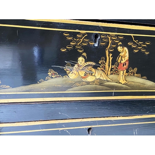 135 - BUREAU, 1930s black lacquered and gilt Chinoiserie decorated with filled interior and three long dra... 