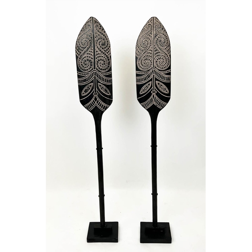 15 - MAORI STYLE PADDLES, a pair, on ebonised stands, 143cm H. (2)