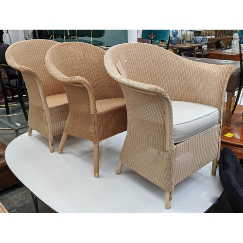 470 - LLOYD LOOM CHAIRS, a set of three, 83cm H, two with cushions, one lacking (with maker's plaques)