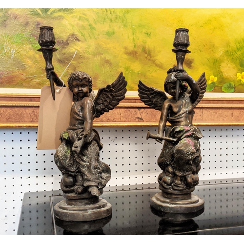 30 - CANDLESTICKS, a pair, each 37cm H in the form of cherubs. (2)