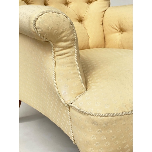 125 - ARMCHAIR, early Victorian walnut with deep button upholstered and cord bound primrose yellow upholst... 