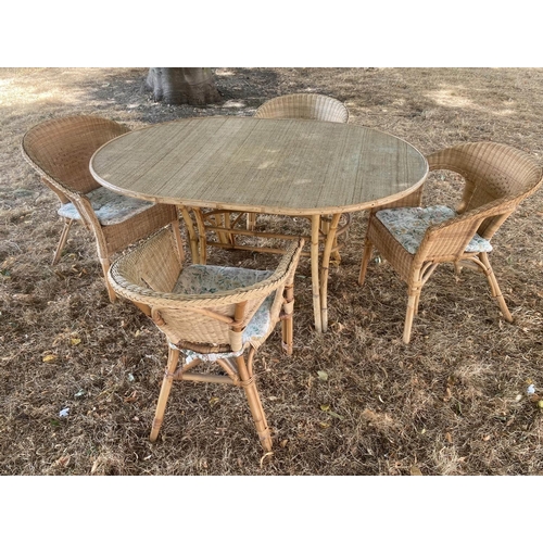 436 - DINING TABLE AND CHAIRS, 1950s oval wicker panelled, bamboo framed and cane bound with splayed suppo... 