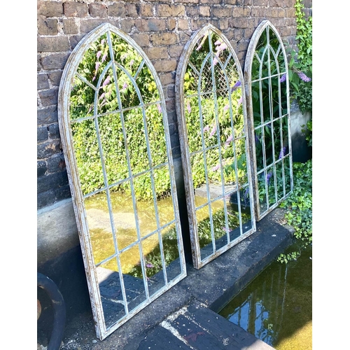 427 - ARCHITECTURAL GARDEN MIRRORS, a set of three, 160cm H x 67cm W, arched aged metal frames with overla... 