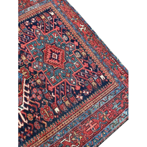 100 - ANTIQUE PERSIAN HERIZ RUG, 195cm x 150cm.