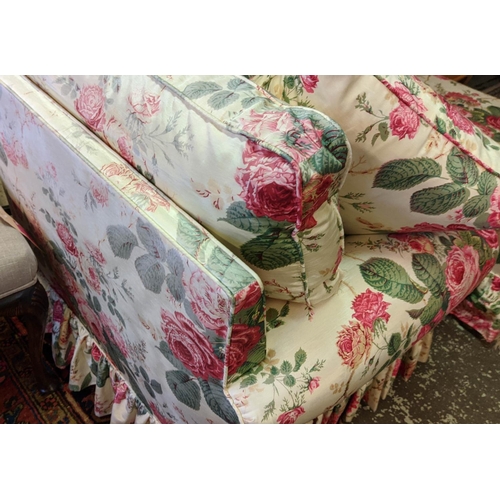 140 - ARMCHAIR, 96cm x 77cm H, floral chintz upholstery and footstool. (2)