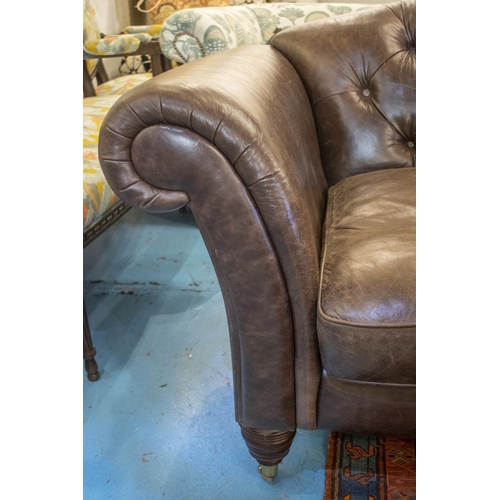 151 - SOFA, 85cm H x 218cm, brown leather with twin seat cushions on front brass castors.