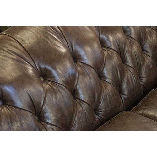 151 - SOFA, 85cm H x 218cm, brown leather with twin seat cushions on front brass castors.