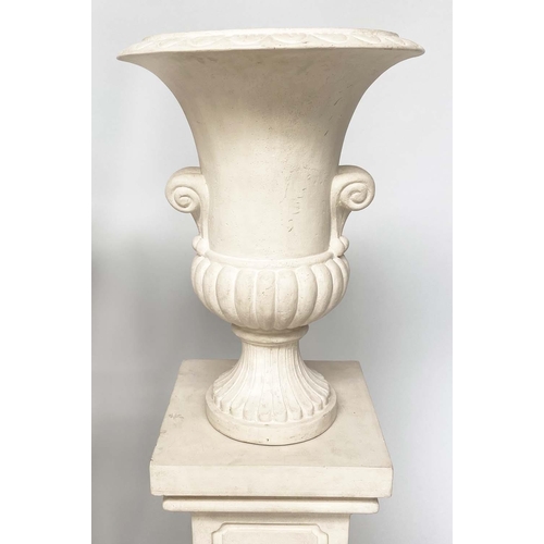 171 - URNS ON STANDS, a pair, campana form stone effect on plinths, 46cm W x 135cm H.