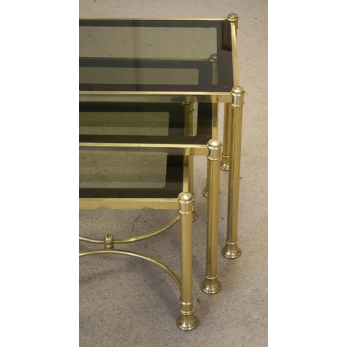 215 - NEST OF THREE TABLES, brass with tinted glass tops, largest 47cm H x 61cm x 40cm.