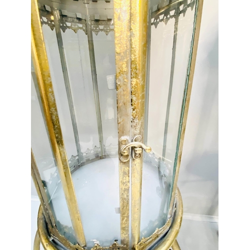 388 - STORM LANTERNS ON STANDS, gilt metal, Regency style, 115cm x34cm x34cm.