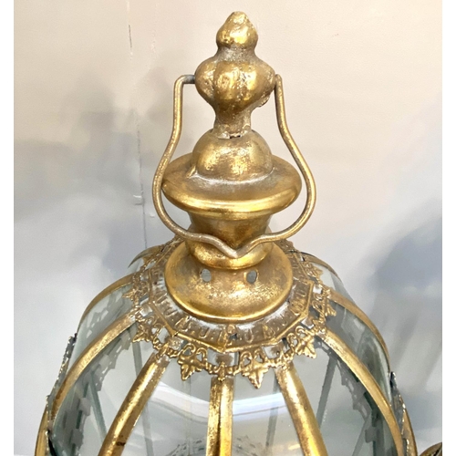 388 - STORM LANTERNS ON STANDS, gilt metal, Regency style, 115cm x34cm x34cm.