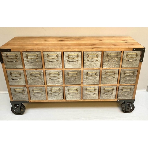 389 - BANK OF DRAWERS, with 21 drawers, on oversized castors, 73cm x123cm x33cm.