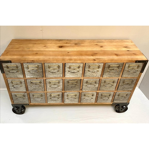 389 - BANK OF DRAWERS, with 21 drawers, on oversized castors, 73cm x123cm x33cm.