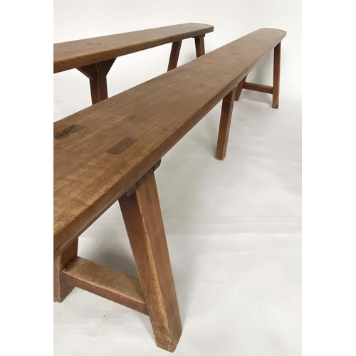 191 - BENCHES, a pair, 19th century French cherry wood rectangular with trestle supports, 231cm W. (2)