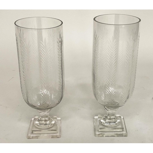 193 - STORM LANTERNS, a pair, hand cut glass with fern decoration, facetted columns and stepped plinths, 4... 