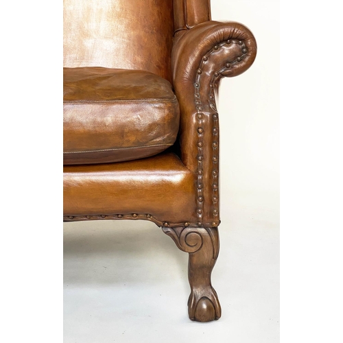 196 - WINGBACK ARMCHAIR, early 18th century style with studded mid brown leather upholstery and carved cla... 