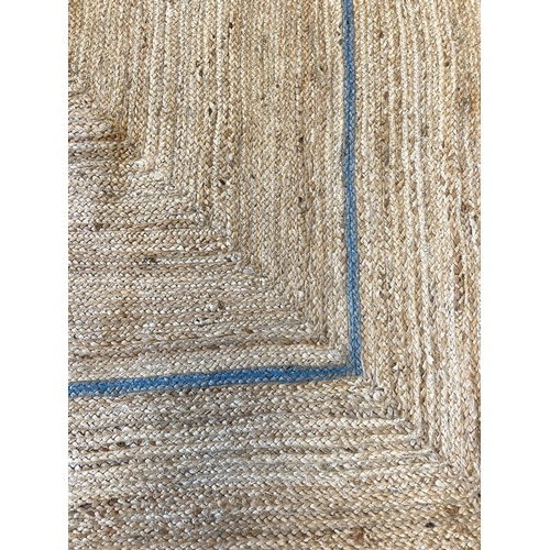 92 - SCALLOPED EDGE JUTE RUG, 310cm x 218cm.