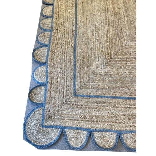 92 - SCALLOPED EDGE JUTE RUG, 310cm x 218cm.