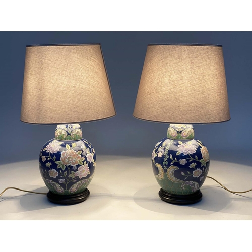 140 - TABLE LAMPS, a pair, Chinese lidded ginger jar form, ceramic with blossom, blue and emerald green gr... 