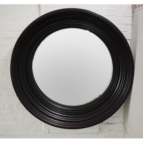 430 - CONVEX WALL MIRROR, Regency style with black frame, 118cm diam x 16cm.