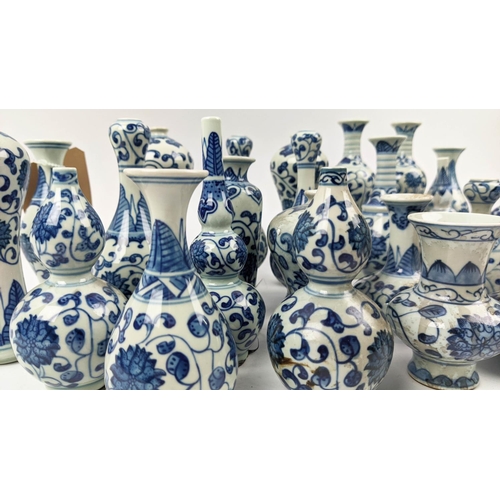 9 - MINIATURE VASES, a collection of twenty five, 17cm approx. at tallest, Chinese export style blue and... 