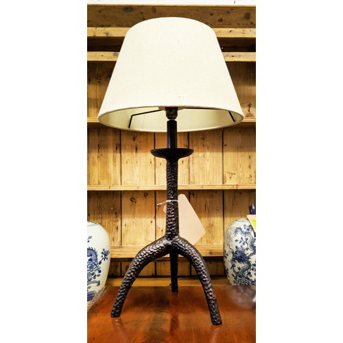 380 - TABLE LAMP, 67cm tall overall including shade, hammered metal tripod support.