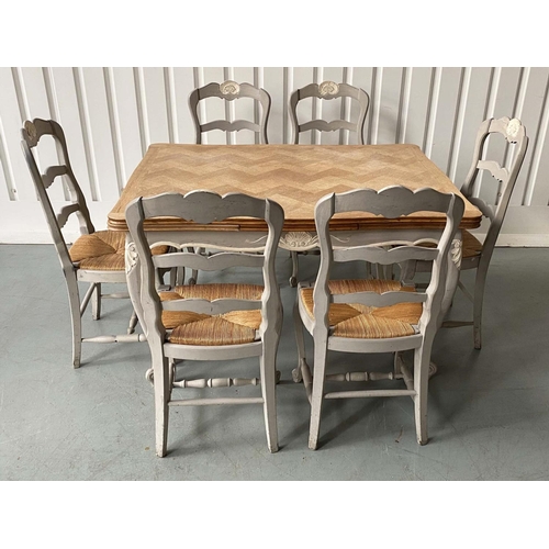 EXTENDING DINING TABLE, French oak parquet and grey painted with pullout leaves and six matching rush seated chairs, 74cm H x 99cm D x 130cm W, 217cm extended.
