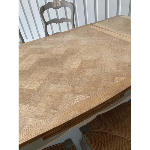 121 - EXTENDING DINING TABLE, French oak parquet and grey painted with pullout leaves and six matching rus... 