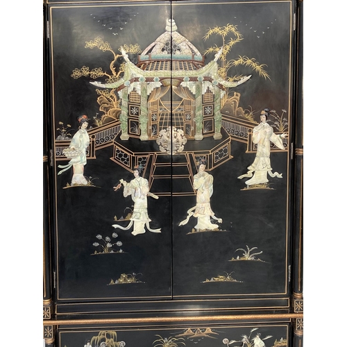 123 - WARDROBE, Chinese lacquered and gilt Chinoiserie decorated with two doors enclosing hanging space an... 