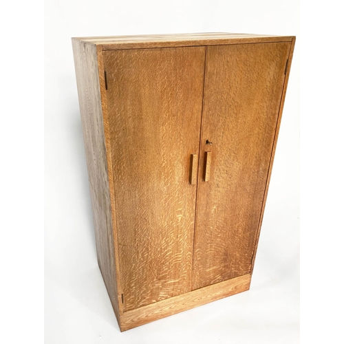 133 - WARDROBE, 1950s oak in the manner of Heals of London with two doors enclosing hanging space and shel... 