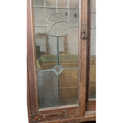 175 - ARTS AND CRAFTS BOOKCASE, early 20th century oak with leaded glazed doors, copper hinges and shelves... 