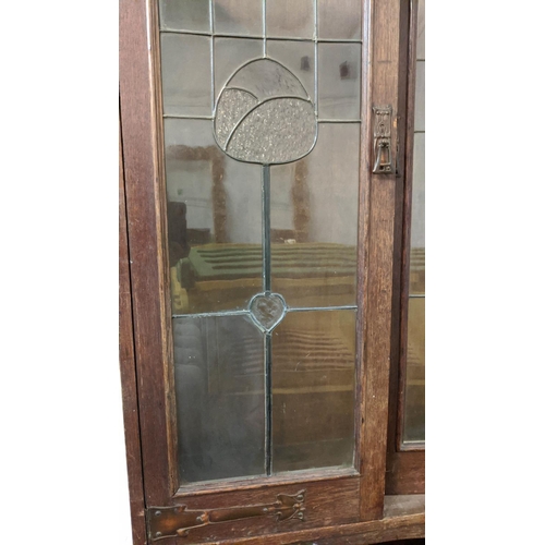 175 - ARTS AND CRAFTS BOOKCASE, early 20th century oak with leaded glazed doors, copper hinges and shelves... 