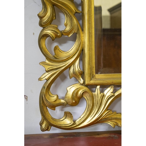 272 - WALL MIRROR, 101cm H x 123cm W, Florentine style giltwood with foliate scrolled frame.