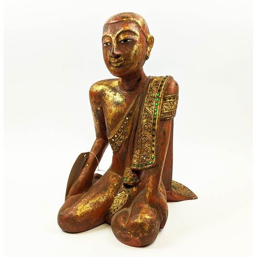 18 - FIGURE OF A THAI MONK, in sitting position, wooden with parcel gilt decoration, applied stones to bo... 