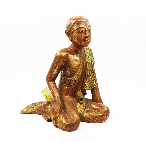 18 - FIGURE OF A THAI MONK, in sitting position, wooden with parcel gilt decoration, applied stones to bo... 