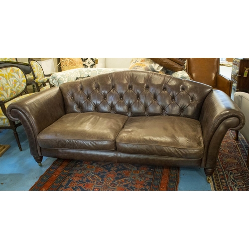 154 - SOFA, 85cm H x 218cm, brown leather with twin seat cushions on front brass castors.