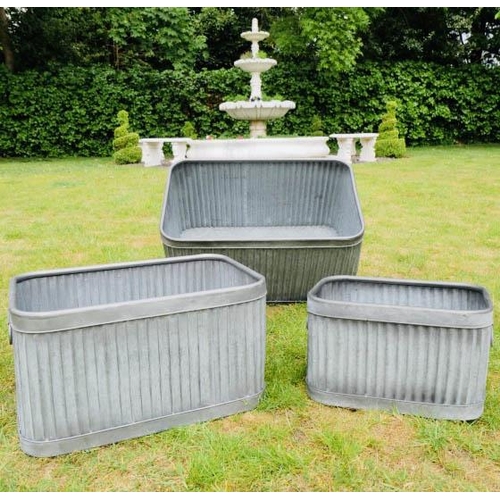 357 - PLANTERS,  a graduated set of three, largest 33cm H x 60cm W x 38cm D, galvanised zinc. (3)