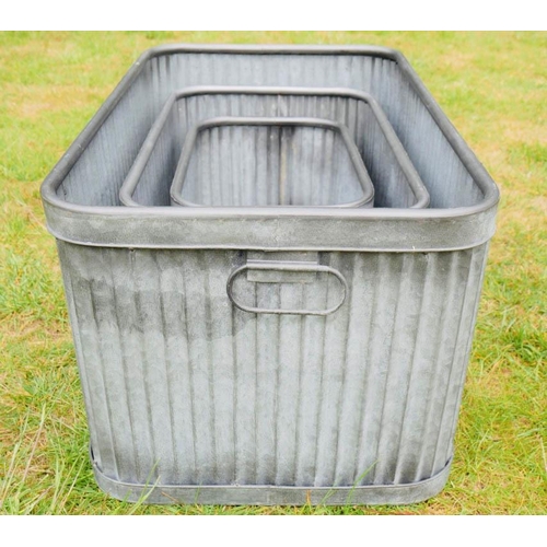 357 - PLANTERS,  a graduated set of three, largest 33cm H x 60cm W x 38cm D, galvanised zinc. (3)